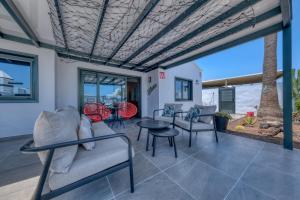 a living room with chairs and a table at Casa Eva - Private Pool, BBQ & Free Parking By Lanzarote Vacation Homes in Los Pocillos