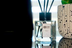 a bottle of perfume sitting next to a vase at W's Condo at One PonteFino Tower in Batangas City +39 photos