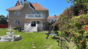 a ladder in front of a large house with at Meszko Park House Budapest in Budapest