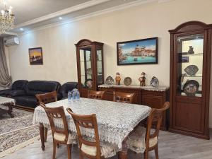 a living room with a table and a couch at Art Apart Residence in Tashkent