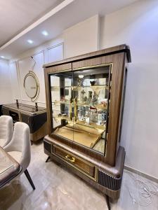 a large display case in a room with a mirror at House in 6th Of October