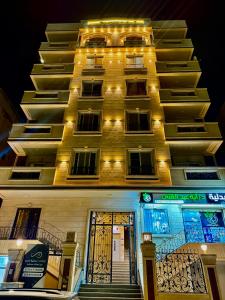 a tall building with a door with lights on it at House in 6th Of October