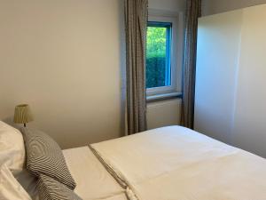 a bedroom with a bed and a window at Ostseemöwe in Warnemünde