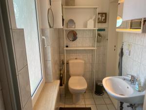 a small bathroom with a toilet and a sink at Ostseemöwe in Warnemünde +17 photos