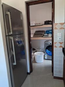 a kitchen with a refrigerator in a room at J and R Villa, Watamu in Watamu