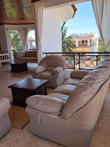 a living room with couches and a table at J and R Villa, Watamu in Watamu