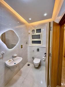 a bathroom with a sink and a toilet at House in 6th Of October