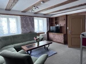 a living room with a couch and a coffee table at Family Zimmer BIGASKY in Ramsen