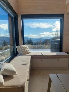 a bedroom with a large window with a view at GOLaskowa in Laskowa
