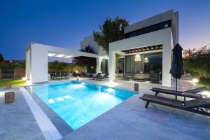 a swimming pool in the backyard of a house at Filerimos Panorama Villa in Pastida