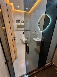 a small bathroom with a toilet and a sink at House in 6th Of October +12 photos