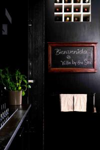 a black kitchen with a sign on the wall at Villa by the Sea in Mala