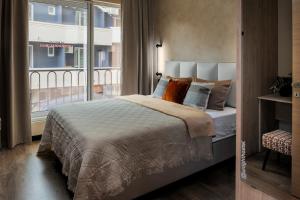 a bedroom with a bed and a large window at U-NIGHT Hostel Budva in Budva