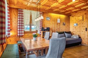a living room with a wooden table and a couch at Hasenhof in Wolfach