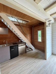 a kitchen with a staircase in a house at Duplex - forêt de Rambouillet in Gambaiseuil