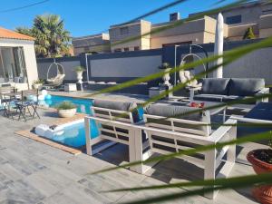 a patio with a table and chairs and a pool at NobelAqua Suites in Maseru