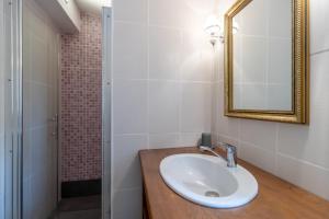 a bathroom with a sink and a mirror and a shower at Chalet En Bois in Saint-Cernin-de-lʼHerm +12 photos