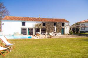 a house with a yard with a pool and chairs at Liiiving in Ofir | Manor Pool House in Fonte Boa