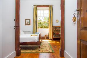 a bedroom with a bed and a window at Liiiving in Ofir | Manor Pool House in Fonte Boa +33 photos