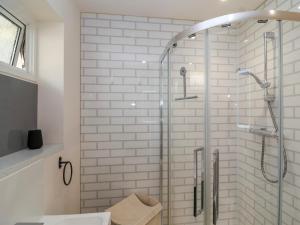 a bathroom with a shower with a glass door at Hillside in Cheltenham +20 photos