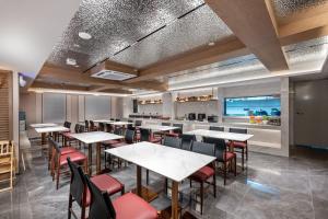 広州市にあるDingshe Hotel Guangzhou Shamian Island Yongqingfang Branchのテーブルと椅子とバーのあるレストラン