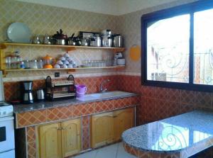 a kitchen with a counter and a sink and a window at Modern villa with pool in Mirleft
