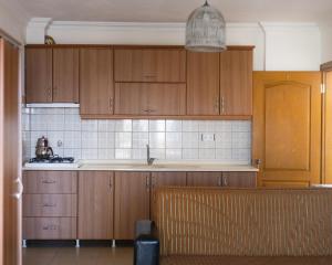 a kitchen with wooden cabinets and a sink at KAJU ROOMS Bozburun in Bozburun +32 photos