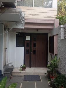a front door of a house with a brown door at Malika Villa in New Delhi