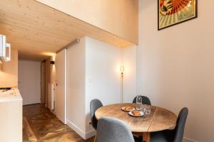 a dining room with a wooden table and chairs at SmartStay Traboule - Place Bellecour in Lyon +19 photos