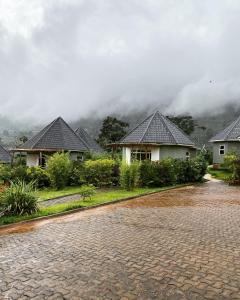 eine regennasse Straße mit Häusern im Hintergrund in der Unterkunft Rafiki Safari Lodge Bwindi in Kinkizi