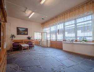 a large room with large windows and a stone floor at Ośrodek Szpulki in Zakopane