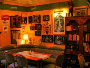 a living room with a couch and a table at Hotel Restaurant Bürgerstube in Ulmen
