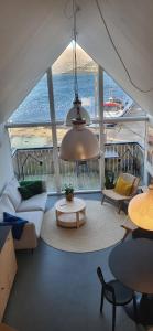 a living room with a view of the water at Charming Apartment in Strendur Faroe Islands, with Stunning Seaview in Strendur