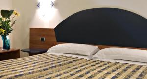 Postel nebo postele na pokoji v ubytování Hotel Marconi