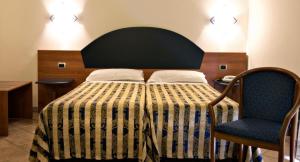 Postel nebo postele na pokoji v ubytování Hotel Marconi