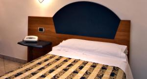 Postel nebo postele na pokoji v ubytování Hotel Marconi