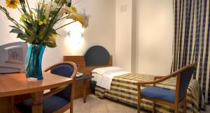 Postel nebo postele na pokoji v ubytování Hotel Marconi