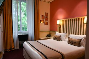 a hotel room with a bed and a window at Napoleon in Ajaccio