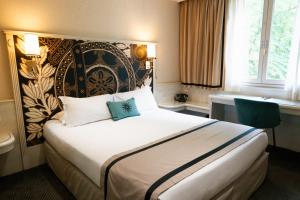 a bedroom with a large bed with a large headboard at Napoleon in Ajaccio