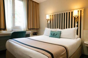 a hotel room with a large bed with two pillows at Napoleon in Ajaccio