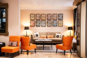 a living room with a couch and orange chairs at Napoleon in Ajaccio