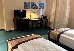 Postel nebo postele na pokoji v ubytování Hotel Lumière an der Messe