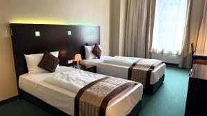 Postel nebo postele na pokoji v ubytování Hotel Lumière an der Messe