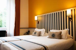 a hotel room with a large bed with two pillows at Napoleon in Ajaccio