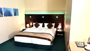 Postel nebo postele na pokoji v ubytování Hotel Lumière an der Messe
