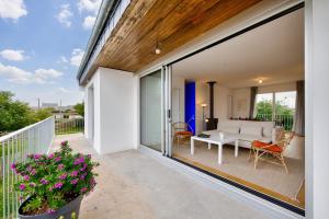 a patio with a white couch and a table at Vue mer - Maison pour 6 avec balcon - Jardin in Plouguerneau
