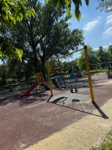 a park with a playground with a swing at MarteNik Apartment, vicino San Raffaele e Milano in Vimodrone