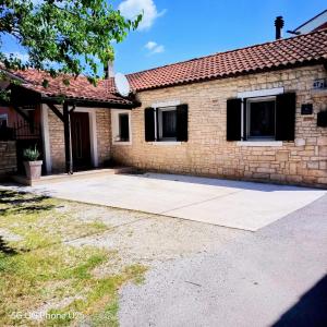 a brick house with a large driveway at Mario and Maria in Vodnjan