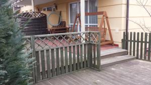 a porch with a fence and a swing at Apartment with Terrace in Rewal