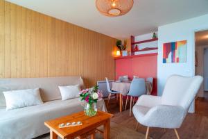 a living room with a couch and a table at Le Mayalou - Vue Mer in Sarzeau